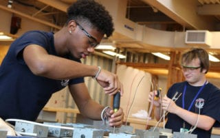 Student working with mechanical tools